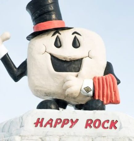Roadside attraction in Gladstone Manitoba: Happy Rock (smiling rock with a top hat).