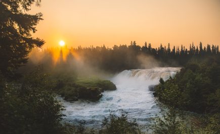 Mist rising over Pisew Falls at sunset.